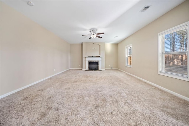 unfurnished living room featuring ceiling fan and light carpet