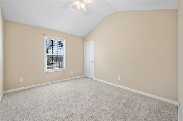 carpeted empty room with ceiling fan and lofted ceiling