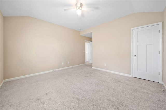 carpeted empty room with ceiling fan and lofted ceiling