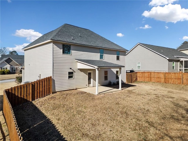 back of house with a patio area and a yard