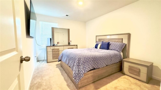 bedroom featuring light colored carpet