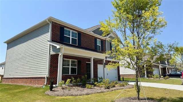 view of front of home with a front yard and a garage