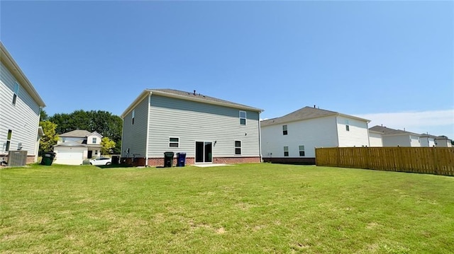 back of house featuring a yard and central AC unit