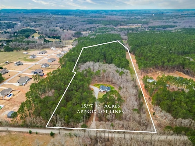 aerial view featuring a wooded view