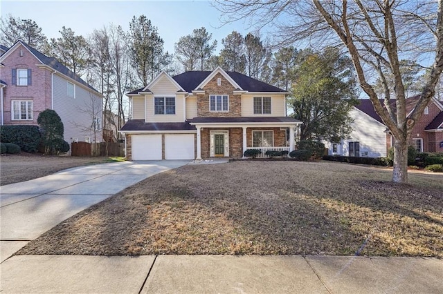 view of property featuring covered porch and a garage