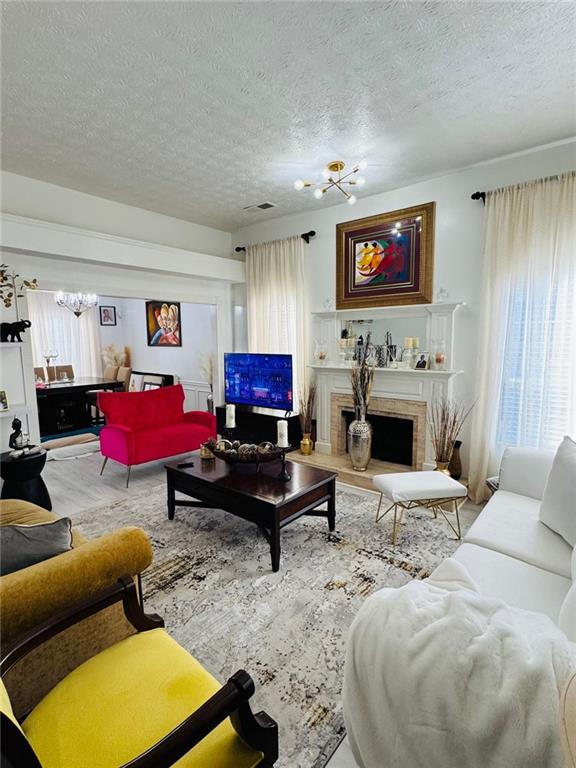 living room featuring a textured ceiling and an inviting chandelier