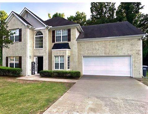 view of front of property with driveway, a garage, stucco siding, and a front yard