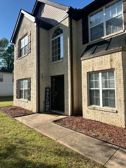 view of front of property featuring brick siding