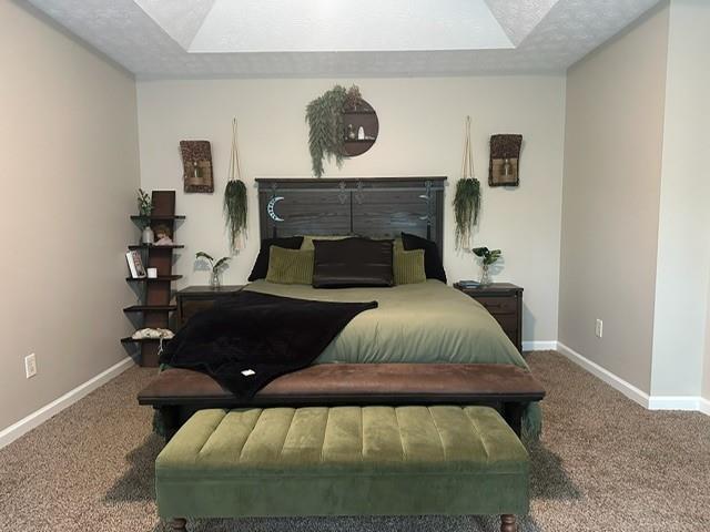 bedroom featuring a textured ceiling, baseboards, and carpet floors