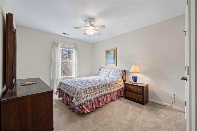 carpeted bedroom featuring ceiling fan, visible vents, and baseboards