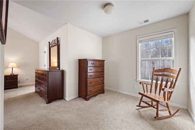 sitting room with light carpet, lofted ceiling, visible vents, and baseboards