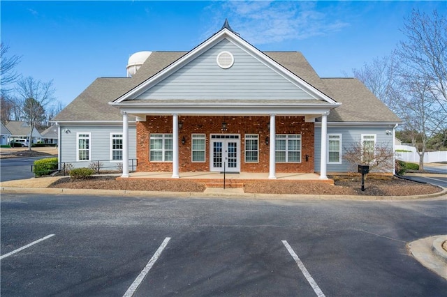 view of building exterior featuring uncovered parking and fence