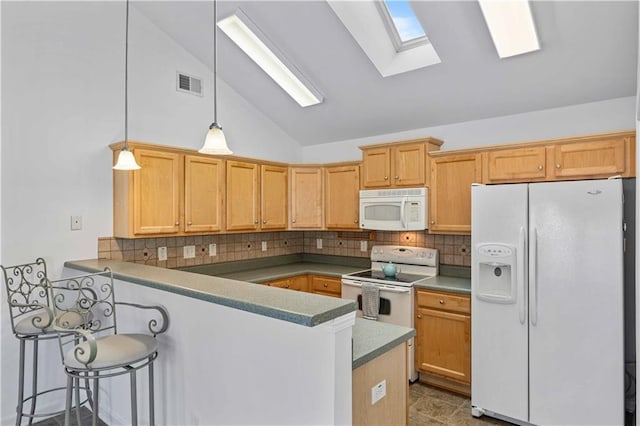 kitchen with pendant lighting, lofted ceiling, visible vents, white appliances, and a peninsula