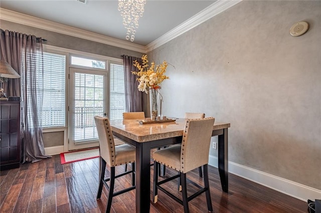 dining area with baseboards, hardwood / wood-style floors, and ornamental molding