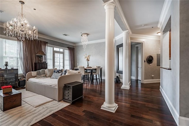 living area with decorative columns, wood finished floors, visible vents, and ornamental molding