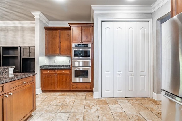 kitchen featuring stainless steel appliances, brown cabinets, and crown molding