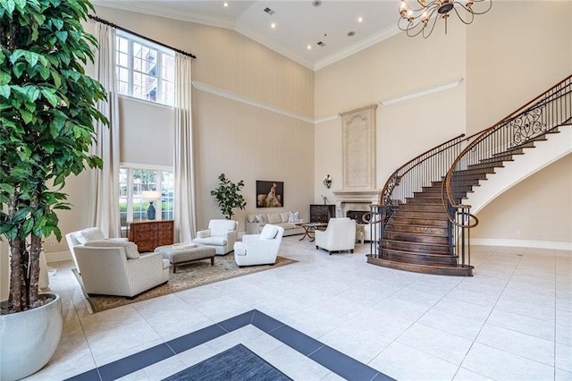 living room featuring a chandelier, stairs, baseboards, and ornamental molding