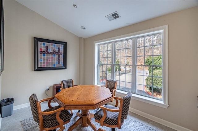 dining room with visible vents, baseboards, and lofted ceiling