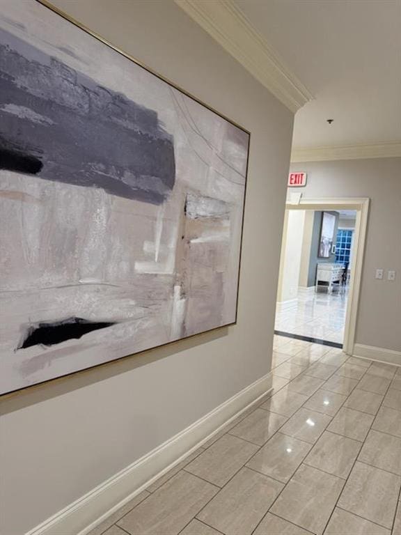 hallway featuring baseboards and ornamental molding