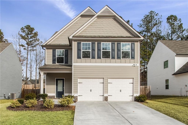 view of front of property featuring central air condition unit, a front lawn, and a garage