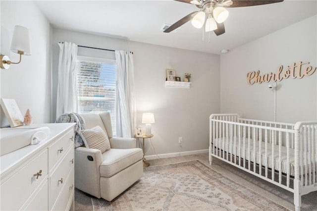 127 Ridgewood Way, Dallas, GA 30132 - bedroom featuring light colored carpet, a nursery area, baseboards, and a ceiling fan