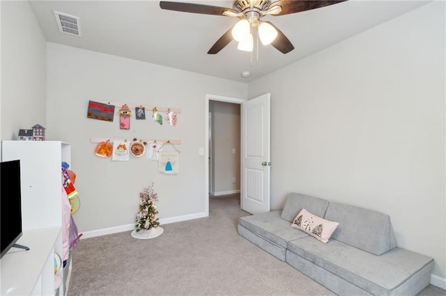 interior space with light colored carpet and ceiling fan