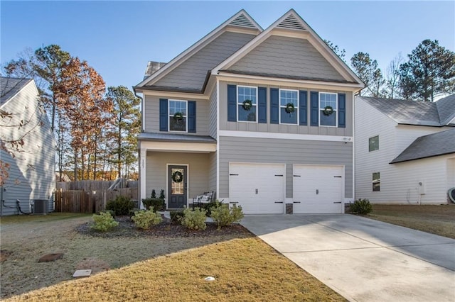 craftsman-style house with central AC unit, a garage, and a front lawn