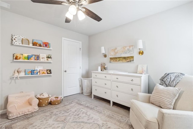 sitting room featuring ceiling fan and light colored carpet