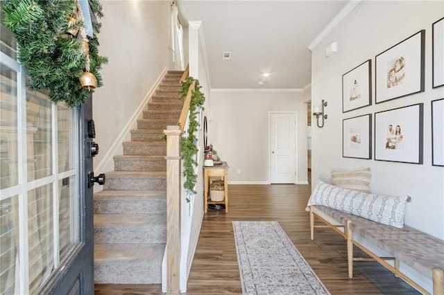 entrance foyer featuring ornamental molding and dark hardwood / wood-style floors