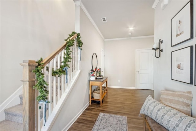 living area featuring hardwood / wood-style floors and crown molding