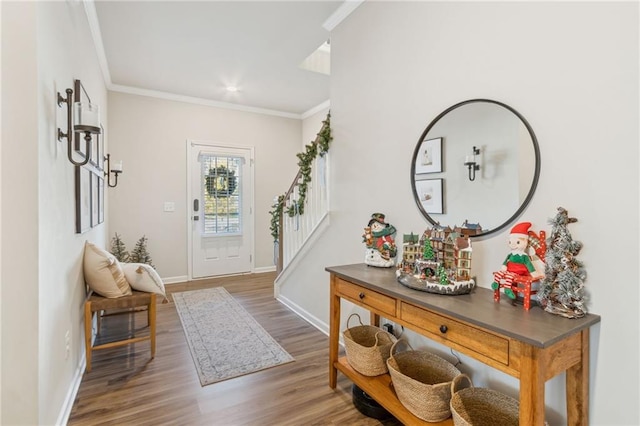 entrance foyer featuring wood-type flooring and crown molding