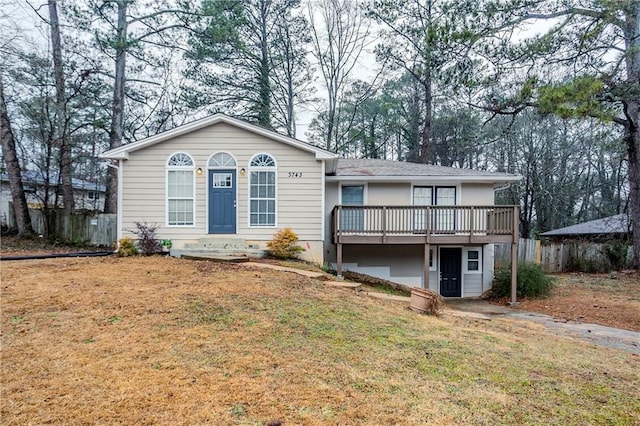 view of front of house featuring a deck and a front lawn