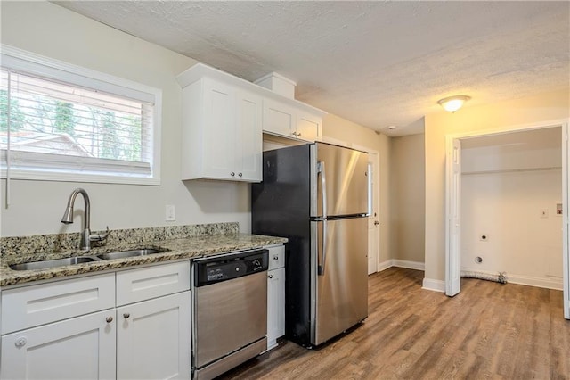 3743 Turner Heights Dr, Decatur, GA 30032 - kitchen with sink, white cabinetry, light wood-type flooring, stainless steel appliances, and light stone countertops