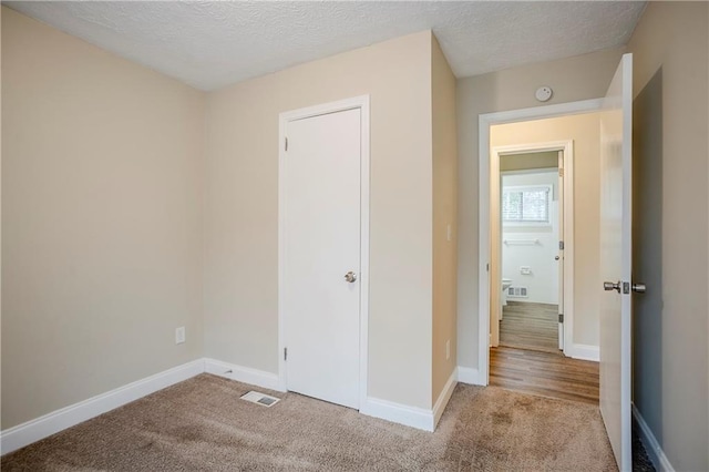 3743 Turner Heights Dr, Decatur, GA 30032 - unfurnished bedroom with light carpet and a textured ceiling