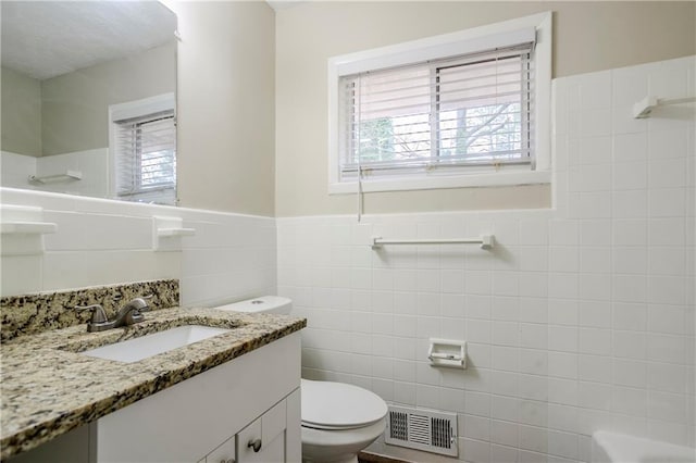 3743 Turner Heights Dr, Decatur, GA 30032 - bathroom featuring vanity, toilet, tile walls, and a shower