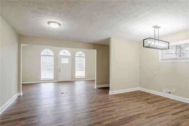 3743 Turner Heights Dr, Decatur, GA 30032 - interior space with dark wood-type flooring, a chandelier, and a textured ceiling