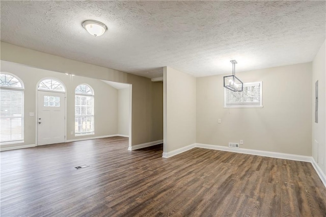 3743 Turner Heights Dr, Decatur, GA 30032 - foyer entrance featuring a textured ceiling, dark wood-type flooring, and a chandelier