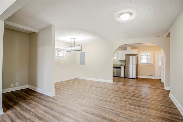 3743 Turner Heights Dr, Decatur, GA 30032 - unfurnished living room with hardwood / wood-style flooring, electric panel, and a textured ceiling