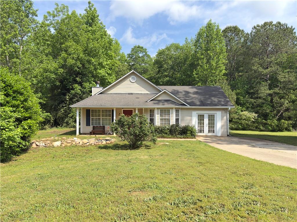204 Bluff Ct, Jackson, GA 30233 - ranch-style home featuring french doors, a front lawn, and a chimney