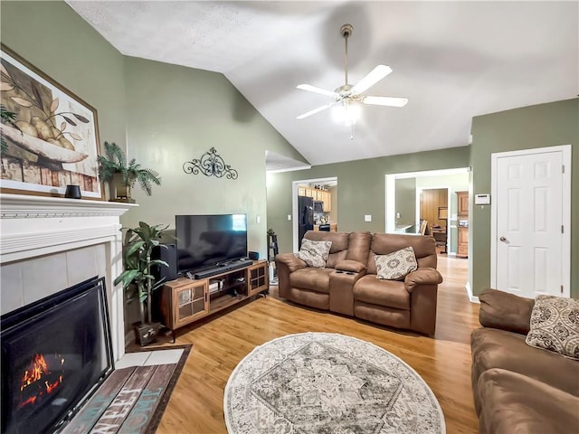 204 Bluff Ct, Jackson, GA 30233 - living room with a tile fireplace, a ceiling fan, light wood-type flooring, and vaulted ceiling