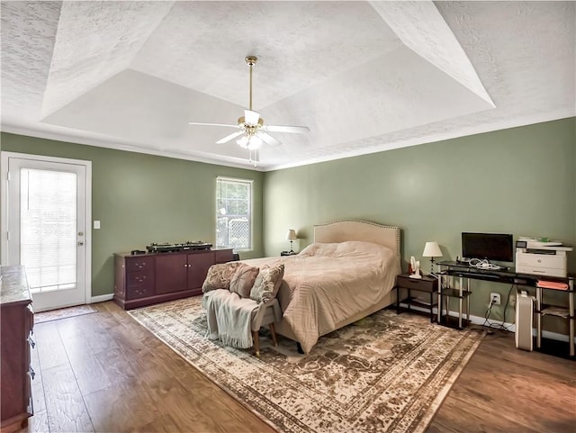204 Bluff Ct, Jackson, GA 30233 - bedroom with a raised ceiling, wood finished floors, baseboards, a textured ceiling, and ceiling fan