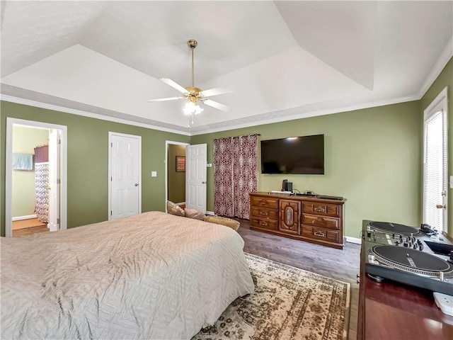 204 Bluff Ct, Jackson, GA 30233 - bedroom with a tray ceiling, wood finished floors, crown molding, a ceiling fan, and baseboards