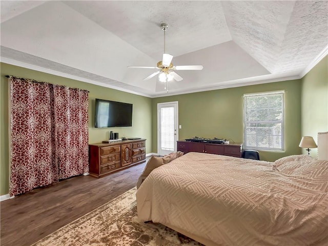 204 Bluff Ct, Jackson, GA 30233 - bedroom featuring a tray ceiling, dark wood finished floors, crown molding, ceiling fan, and a textured ceiling