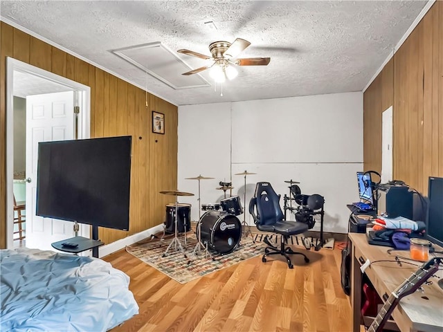 204 Bluff Ct, Jackson, GA 30233 - playroom with wooden walls, a ceiling fan, wood finished floors, a textured ceiling, and attic access
