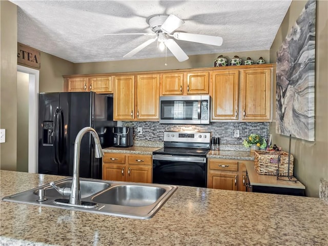 204 Bluff Ct, Jackson, GA 30233 - kitchen featuring appliances with stainless steel finishes, a sink, ceiling fan, a textured ceiling, and light countertops
