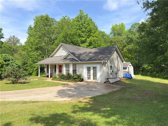 204 Bluff Ct, Jackson, GA 30233 - view of front of house featuring french doors, a front lawn, a porch, and a storage unit