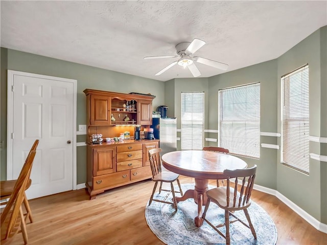 204 Bluff Ct, Jackson, GA 30233 - dining area with light wood-type flooring, baseboards, and a ceiling fan