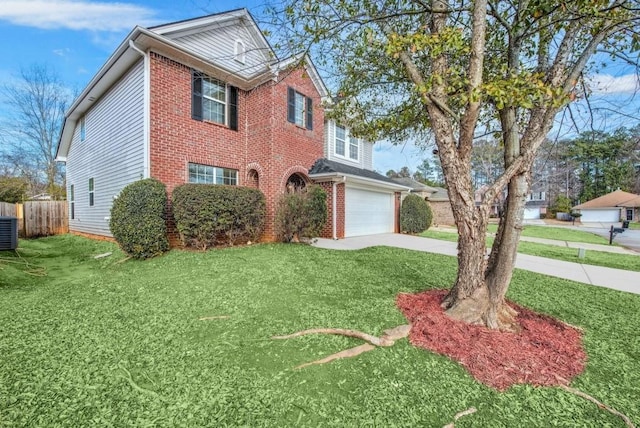 view of front of property featuring a garage, central AC, and a front lawn