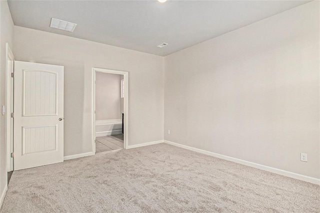 unfurnished room featuring carpet flooring, baseboards, and visible vents