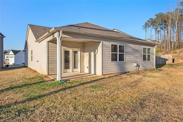 rear view of house with a yard and a patio